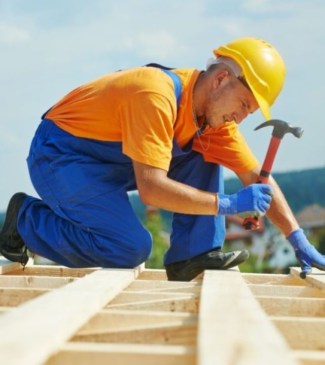 Roofer Carpenter Works on Roof